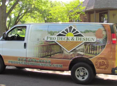 Professional service van for Pro Deck & Design in Kansas City displaying company logo, custom deck portfolio images, 30+ years of experience badge, website URL, and local phone number 913-209-4055 serving Johnson, Wyandotte, and Leavenworth Counties