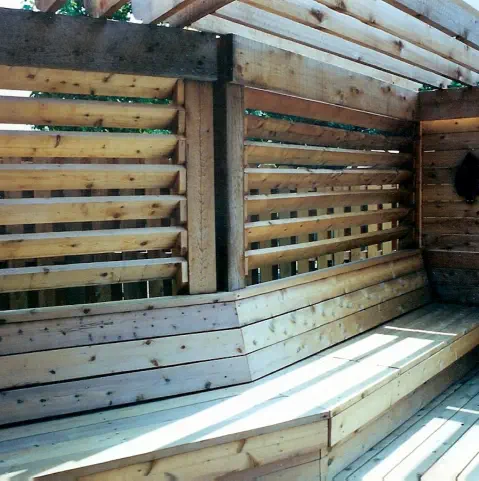 Custom cedar privacy screen with integrated bench seating built by Pro Deck & Design in Kansas City, showcasing innovative outdoor living solutions and expert carpentry for private deck spaces in Wyandotte County homes