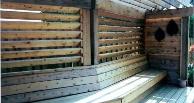 Custom cedar privacy screen with integrated bench seating built by Pro Deck & Design in Kansas City, showcasing innovative outdoor living solutions and expert carpentry for private deck spaces in Wyandotte County homes