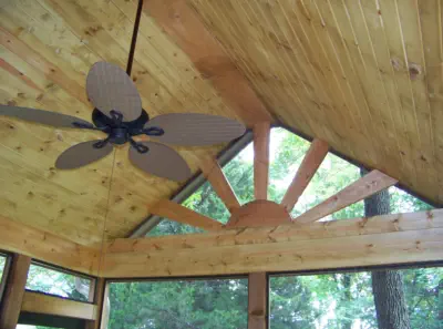 Custom vaulted cedar ceiling in Kansas City screened porch featuring professional carpentry, sunburst window design, and quality construction by experienced Kansas contractors specializing in premium outdoor living spaces
