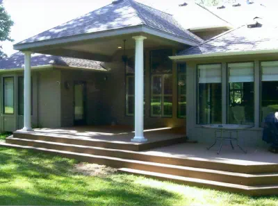 Custom covered porch addition in Kansas City featuring professional roof integration, quality wooden steps, and expert construction by experienced Kansas contractors specializing in premium outdoor living enhancements