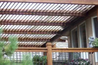 Custom cedar pergola with distinctive slat design built by Pro Deck & Design in Kansas City, providing stylish partial shade for deck area while enhancing outdoor living spaces for Johnson County homeowners