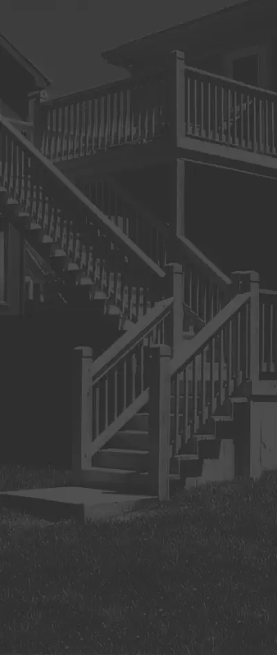 Professional multi-level deck with custom staircase design built by Pro Deck & Design in Kansas City, featuring expert craftsmanship, quality railings, and safe access between levels for elegant evening entertainment in Johnson County homes