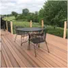 Beautiful composite deck with black aluminum railings built by Pro Deck & Design in Kansas City, featuring durable low-maintenance decking, elegant outdoor dining space, and scenic backyard views perfect for Johnson County outdoor living