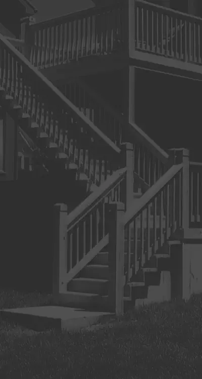 Professional multi-level deck with custom staircase design built by Pro Deck & Design in Kansas City, featuring expert craftsmanship, quality railings, and safe access between levels for elegant evening entertainment in Johnson County homes