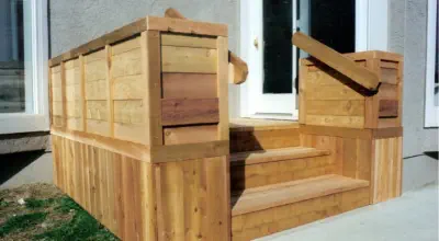 Custom cedar entry deck with integrated privacy screens built by Pro Deck & Design in Kansas City, featuring expert carpentry, built-in storage solutions, and compact design perfect for front entrances of Leavenworth County homes