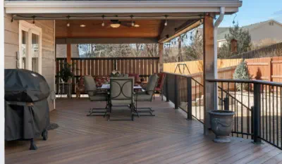 Custom-built covered deck in Kansas City featuring premium composite decking, professional installation, and complete outdoor living amenities for year-round enjoyment in Missouri weather