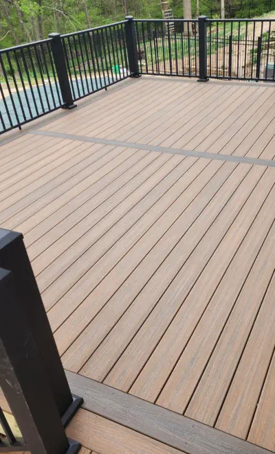 Professionally installed composite deck in Kansas City with premium weather-resistant materials, featuring custom black railings and expert craftsmanship perfect for Missouri outdoor living spaces and pool areas