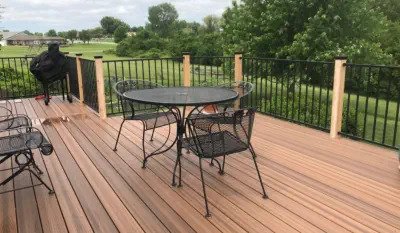 Custom-built cedar-tone composite deck in Kansas City with premium materials and panoramic views, featuring professional installation, quality metal railings, and the perfect outdoor entertaining space for Kansas homeowners