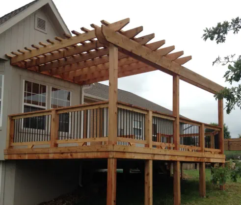 Custom elevated cedar deck and pergola in Kansas City designed for sloped yards, featuring expert construction techniques, quality natural materials, and professional installation by trusted Kansas outdoor living specialists