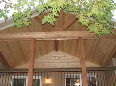 Custom cedar porch ceiling in Kansas City featuring exposed beams, quality tongue-and-groove construction, and professional installation by experienced Kansas contractors specializing in natural wood outdoor living spaces