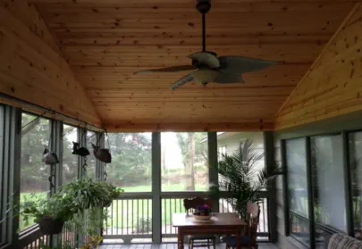 Custom cedar-lined screened porch in Kansas City featuring premium wood paneling, professional construction, and climate-controlled design perfect for extending Kansas outdoor living throughout multiple seasons