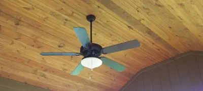Premium cedar tongue-and-groove ceiling in Kansas City covered porch featuring professional installation, quality materials, and custom design by experienced Kansas contractors specializing in all-season outdoor living spaces