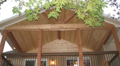 Custom cedar porch ceiling in Kansas City featuring exposed beams, quality tongue-and-groove construction, and professional installation by experienced Kansas contractors specializing in natural wood outdoor living spaces