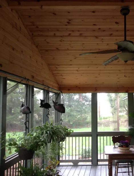 Custom cedar-lined screened porch in Kansas City featuring premium wood paneling, professional construction, and climate-controlled design perfect for extending Kansas outdoor living throughout multiple seasons