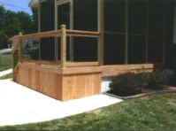Custom cedar-framed screened porch in Kansas City with professional concrete patio installation, featuring quality materials and expert construction by experienced Kansas contractors specializing in multi-level outdoor living spaces