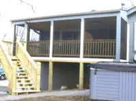 Custom two-level deck and screened porch in Leavenworth County Kansas featuring professional installation, space-maximizing design, and quality construction by experienced Kansas contractors specializing in innovative outdoor living solutions