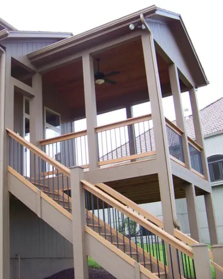 Elevated deck with covered porch in Wyandotte County featuring cedar ceiling, quality staircase construction, and professional installation by expert Kansas contractors specializing in all-weather outdoor living spaces
