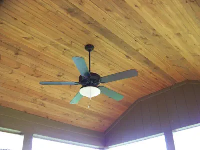 Premium cedar tongue-and-groove ceiling in Kansas City covered porch featuring professional installation, quality materials, and custom design by experienced Kansas contractors specializing in all-season outdoor living spaces