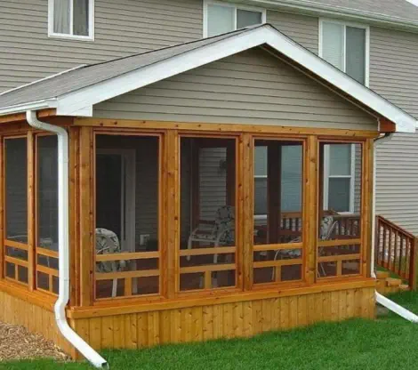 Custom cedar screened porch built by Pro Deck & Design in Kansas City, featuring quality craftsmanship with wooden framing, full screening for bug-free enjoyment, and seamless integration with existing Johnson County home